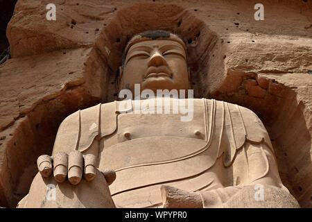 LANZHOU, Gansu Province, China - ca. Mai 2017: Buddha Statue an Anja Cave Tempel (UNESCO-Weltkulturerbe). Stockfoto