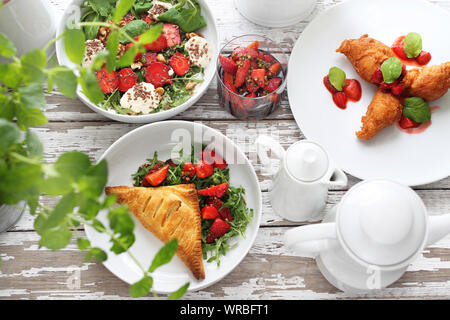 Erdbeere Gerichte. Blätterteig mit Ricotta, Quark und Erdbeere, Salat, Erdbeeren in Aceto Balsamico mit grünem Pfeffer, Erdbeere Pfannkuchen Stockfoto