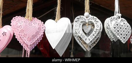 Geschenk Herz aus Eisen und Holz hängen an einem Seil in einer Reihe. Banner Stockfoto
