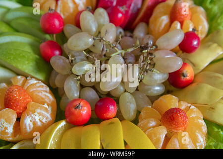 Weiße Trauben, rote Äpfel, Mandarinen, Erdbeeren, Zitronen. Frische Früchte. sortierte Früchte bunten Hintergrund. Scheiben bunte Früchte. Obst Stockfoto