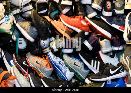 Ein riesiges Durcheinander Sammlung von Sportschuhen, Trainer sind für den Verkauf am Central Market in Phnom Penh, Kambodscha. Stockfoto