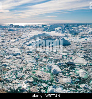 Eisberg und Eis vom Gletscher in den arktischen Natur Landschaft auf Grönland. Luftbild Drohne Foto von Eisbergen in Ilulissat Eisfjord. Durch den Klimawandel und die globale Erwärmung betroffen. Stockfoto