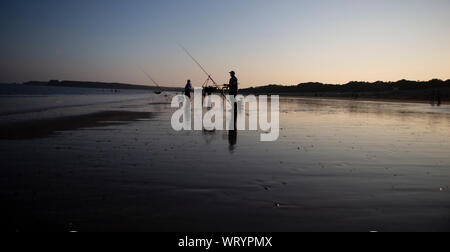 Tenby, Wales - 26. August 2019: Fischer auf einem Strand in Tenby, Vereinigtes Königreich Stockfoto