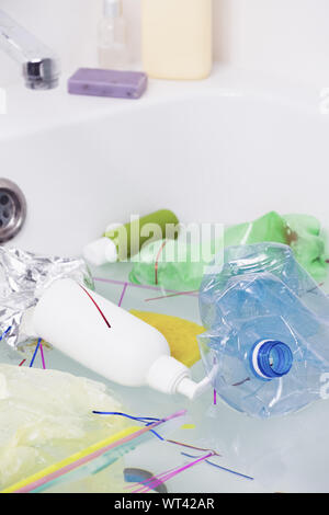 Kunststoff Papierkorb in der Badewanne. Das Konzept der Umweltverschmutzung mit Plastikmüll und die Gefahr der microplastics für die menschliche Gesundheit. Stockfoto