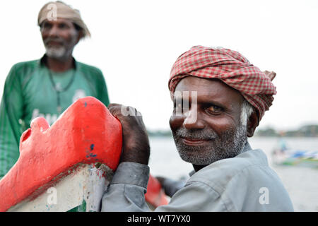 COCHIN, Indien - 30. NOVEMBER 2018: Portrait des Fischers von Fort Cochin gegen ein Fischerboot schiefen Stockfoto