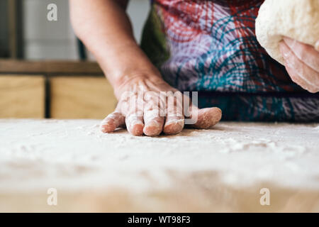 Qualifizierte Bäcker Frau Teig kneten. Professionelle Bäckerei Konzept. Stockfoto