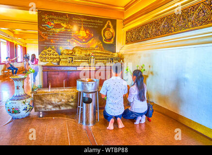 BANGKOK, THAILAND - 24 April 2019: Das junge Paar beten im Golden Liegenden Buddha im Gebet Hall des Wat Saket (Golden Mount) Tempel, am 2. April Stockfoto