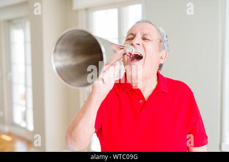 Älterer Mann shouthing durch vintage Metall Megaphon aufgeregt Stockfoto