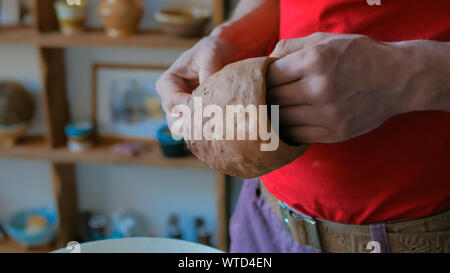 Professionelle männlichen potter Prüfung Becher in Töpferei Stockfoto