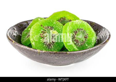 Viele Scheiben süß grün kandierte Kiwis in dunklen Keramik Schüssel auf weißem Hintergrund Stockfoto