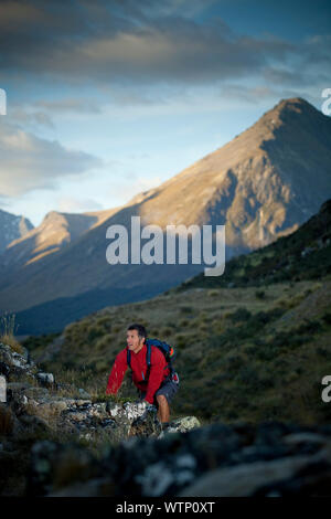 Dallas Hewett wandern mit dem Berg zu den Mavora im Hintergrund, Southland, Neuseeland. Stockfoto