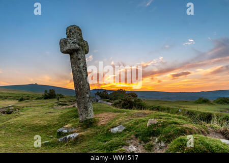 Windigen Post Dartmoor England alten steinernen Kreuz am windigen Post, bei Sonnenaufgang gesehen Stockfoto