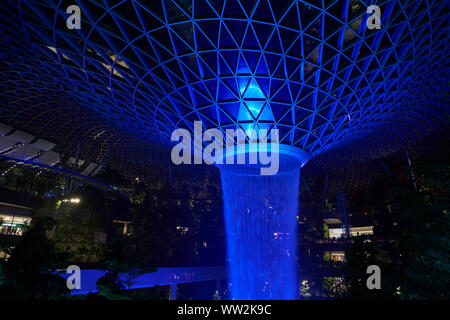 Singapur - ca. April 2019: 40 meter HSBC Regen Wirbel, der weltweit höchsten Wasserfall an der Juwel Changi Airport in der Nacht. Stockfoto