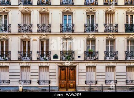 Blick auf die Straße von der eleganten Fassade eines alten Wohnhaus in einem Wohngebiet von Paris. Vintage Style Foto. Stockfoto