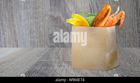 Einkaufen Konzept, Supermarkt Retail Product in der braunen Papiertüte auf Holz Hintergrund Stockfoto