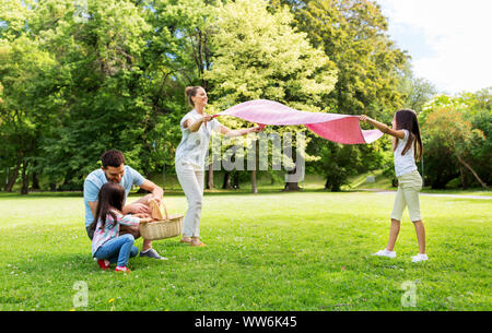 Familie zur Festlegung Picknickdecke im Sommer Park Stockfoto