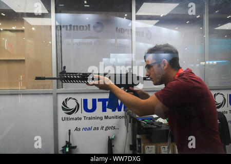 London, Großbritannien. 13 Sep, 2019. Ein delegierter Feuer live Munition auf das ultimative Trainingsgerät Munition Demonstration stand während des letzten Tages der DSEI Waffen-Messe in ExCel, größten Waffen der Welt, die alle zwei Jahre in den Londoner Docklands gehalten wird. Credit: Amer Ghazzal/SOPA Images/ZUMA Draht/Alamy leben Nachrichten Stockfoto