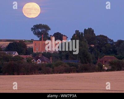 Eastchurch, Kent, Großbritannien. 13. September, 2019. UK Wetter: Die vollständige Harvest Moon gesehen steigende über historische Shurland Halle (wo Henry VIII seine Flitterwochen verbracht) in Eastchurch, Kent an diesem Abend. Credit: James Bell/Alamy leben Nachrichten Stockfoto