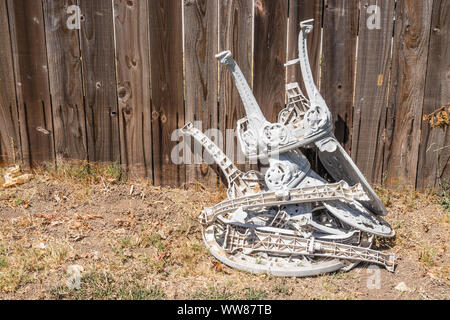 Zwei Kunststoff Gartenstühle und einen passenden Tisch, die zerstört worden sind, werden in einem Haufen warten in einem Vorgarten recycelt werden gestapelt. Stockfoto