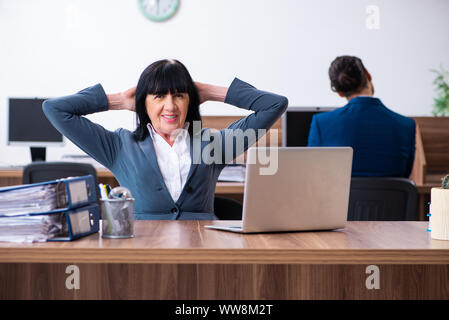 Die beiden Mitarbeiter, die sportliche Übungen im Büro Stockfoto