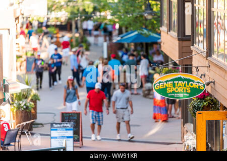Aspen, USA - Juli 4, 2019: Snowmass Village Stadt und Menschen Shopping mall Hohe Betrachtungswinkel in Colorado Innenstadt mit vielen Sport Store anmelden Stockfoto