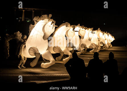 Aufblasbare leuchtende weiße Pferde während Kunst FierS einen Cheval an der denkmalgeschützten Piece Hall, in Halifax, Yorkshire. Stockfoto