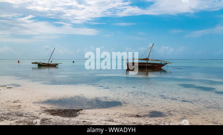 Sansibar in Tansania, typische Fischerboot an einem wunderschönen Strand mit Wellen Stockfoto