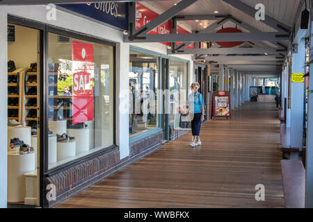 Eine ältere Frau im shop Fenster einen Blick auf einer Promenade in Port Solent, Portsmouth, Großbritannien Stockfoto