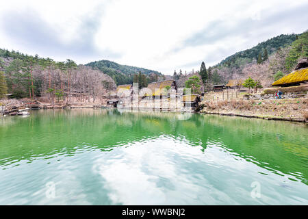 Takayama, Japan - April 7, 2019: Holz- Haus Gebäude im traditionellen Hida keine Sato alten Folk Village von grünen Teich See im Frühjahr Stockfoto