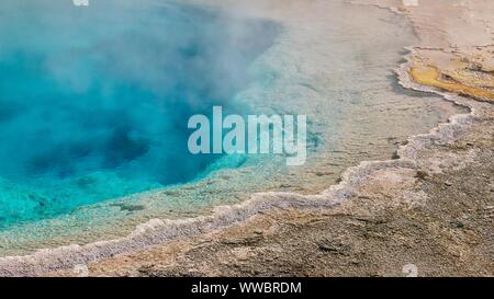 Eine Nahaufnahme eines dampfenden Türkis hot spring Pool und der rauen Kruste um die Kanten. Silex Feder am unteren Geyser Basin, Yellowstone N.P Stockfoto