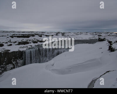 Die verschneite Landschaft am Wasserfall Dettifoss in Island Stockfoto