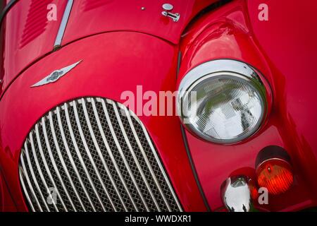 Vor einer roten Morgan Sports Car, Abzeichen, Kühlergrill, Scheinwerfer und Blinker Licht. Stockfoto