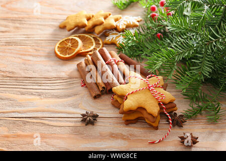 Leckere Weihnachtsplätzchen, Zimtstangen und tanne Zweig auf hölzernen Tisch Stockfoto