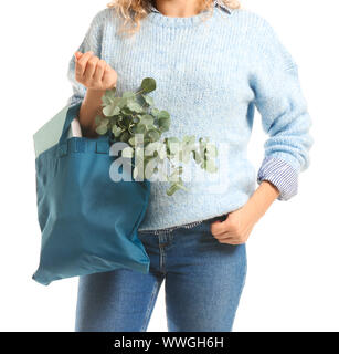 Frau mit Buch und Eukalyptus in eco Beutel auf weißem Hintergrund, Nahaufnahme Stockfoto