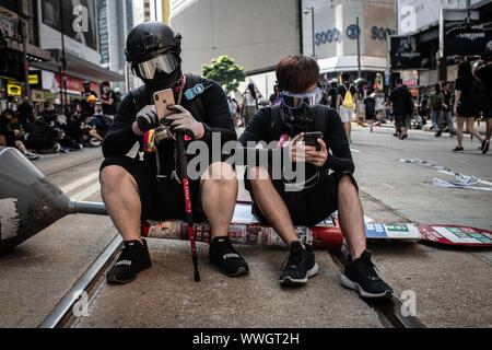 Hong Kong. 15 Sep, 2019. Die Demonstranten sitzen auf der Straße, wie sie Teil während einer pro-demokratischen März nehmen. Die Demonstranten weiter über Hongkong für die 15 nachfolgende Woche zu demonstrieren. Nach dem Marsch für ein paar Stunden von Causeway Bay in Richtung Admiralität, Auseinandersetzungen zwischen Demonstranten und der Polizei kam es in verschiedenen Teilen der Insel. Credit: SOPA Images Limited/Alamy leben Nachrichten Stockfoto