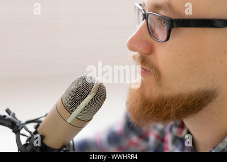 Radio, DJ, Blogging und Personen Konzept - Close-up des Menschen vor dem Mikrofon sitzen, Host am Radio Stockfoto