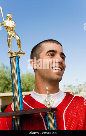 Baseball Player Holding Trophy Stockfoto