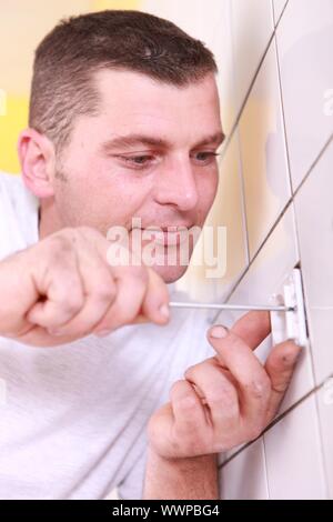 Handwerker, die Schrauben einer Steckdose Stockfoto