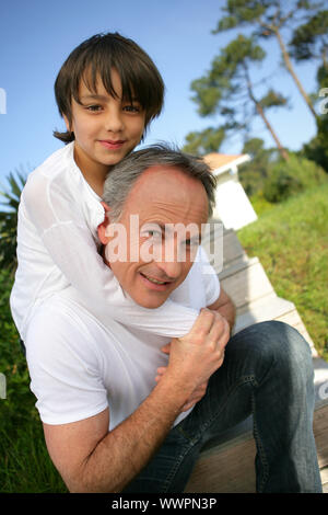 Kleine Junge saß auf den Schultern seines Vaters Stockfoto
