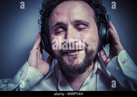 Genießen Sie die Musik, Mann mit intensiven Ausdruck, weißes Hemd Stockfoto