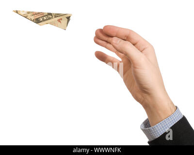 Ein Mann handgemachte wirft einen Papierflieger von einer zehn-Dollar-Schein. Stockfoto