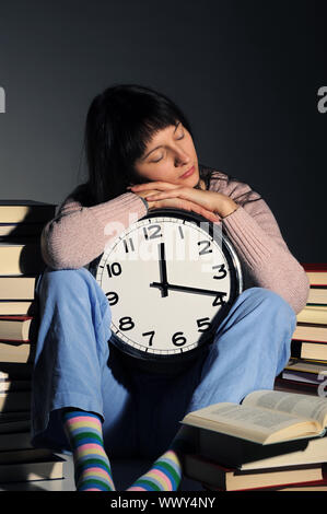 Student schlief auf Stapel des Buches während seine Hausaufgaben. Stockfoto