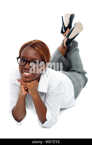 Entspannte afrikanischen Geschäftsfrau am Boden liegend. Indoor Studio gedreht Stockfoto
