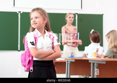 Portrait von Schulmädchen mit einer Schule Rucksack, schauen aus dem Fenster Stockfoto