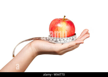 Hand extened mit einem Apple ruht und in ein flexibles Maßband gewickelt. Stockfoto