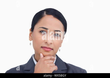 Nahaufnahme von verkaeuferin in Denker Pose vor einem weißen Hintergrund Stockfoto