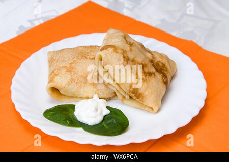 Stapel Pfannkuchen mit Füllung auf einer weißen Platte Stockfoto