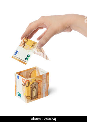 Hände und Geld Haus Stockfoto