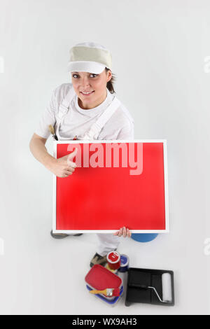 Maler auf ein leeres rotes Schild Stockfoto