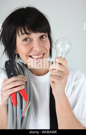 Weibliche Elektriker holding Ersatz Verkabelung und Birne Stockfoto